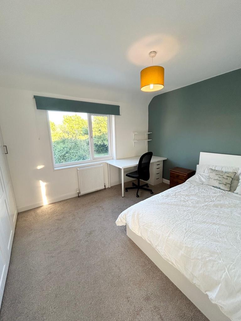 A bright and spacious double bedroom featuring ...