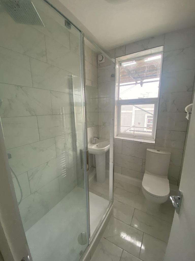 A modern and clean bathroom with a spacious sho...