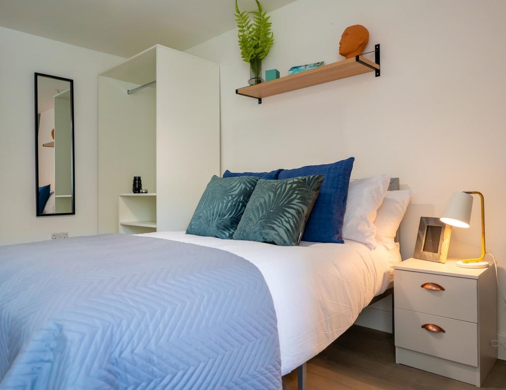 A bright and stylish double bedroom with modern...