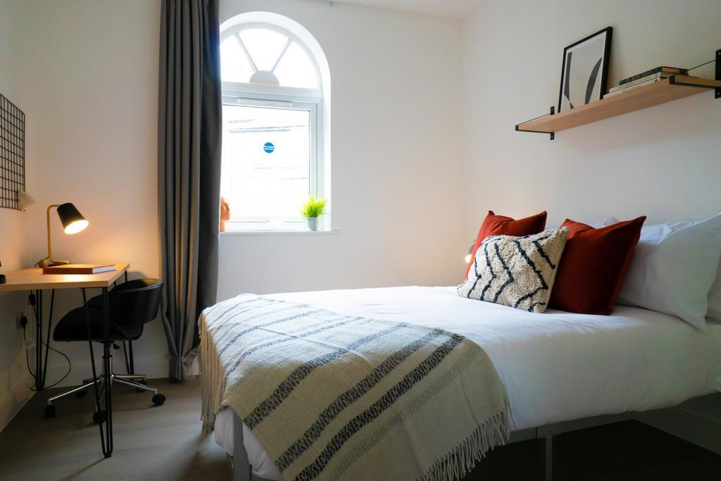 A bright and inviting double bedroom featuring ...