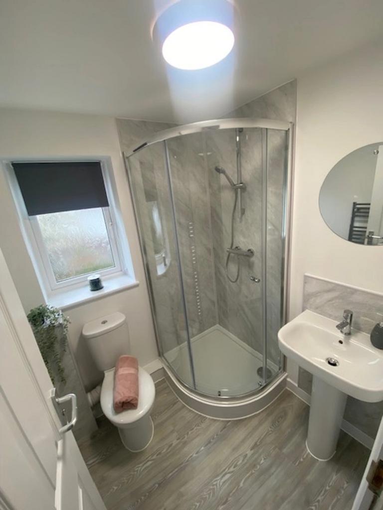 A modern and stylish bathroom featuring a spaci...