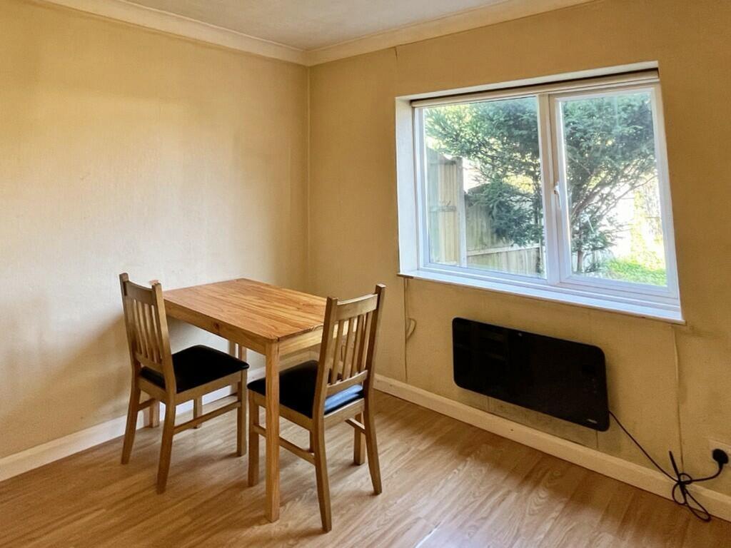 A bright and tidy kitchenette with a dining tab...