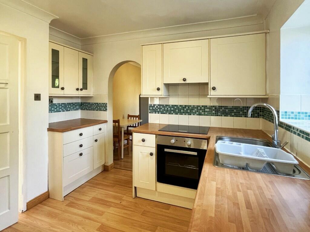 A bright and tidy kitchen with modern fixtures,...