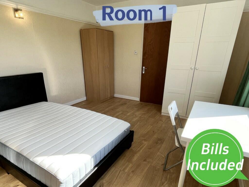 A bright and spacious double bedroom with moder...