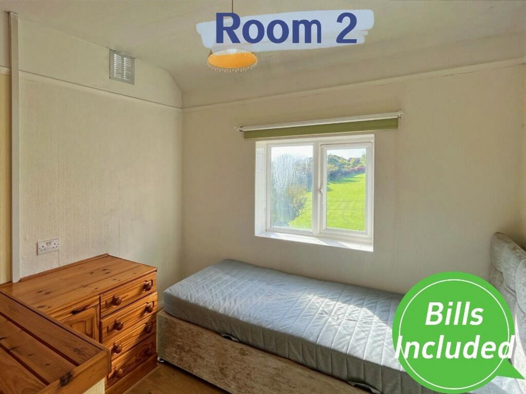 A bright and tidy double bedroom featuring a co...