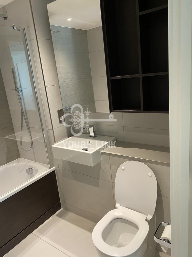A modern and clean bathroom featuring a bath an...
