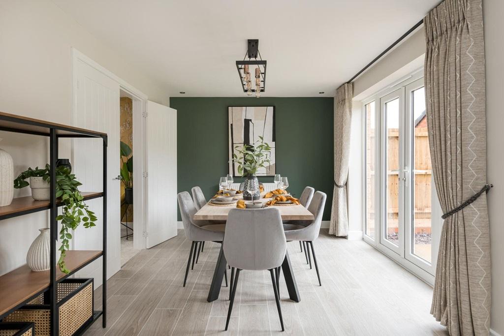 The dining area features French doors which...