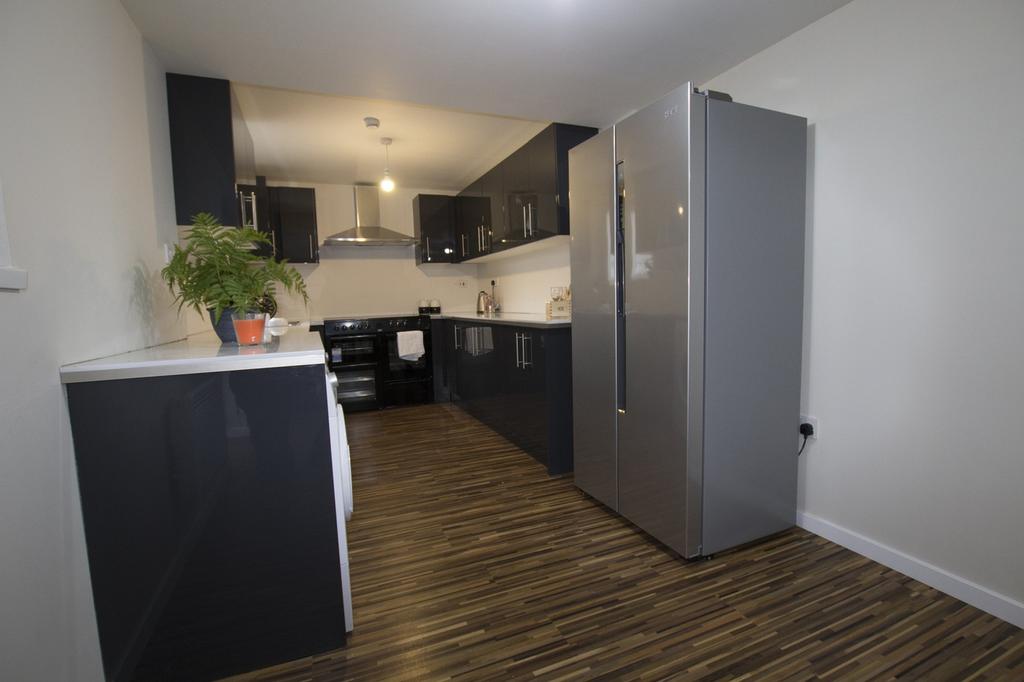 A modern and spacious kitchen featuring sleek c...