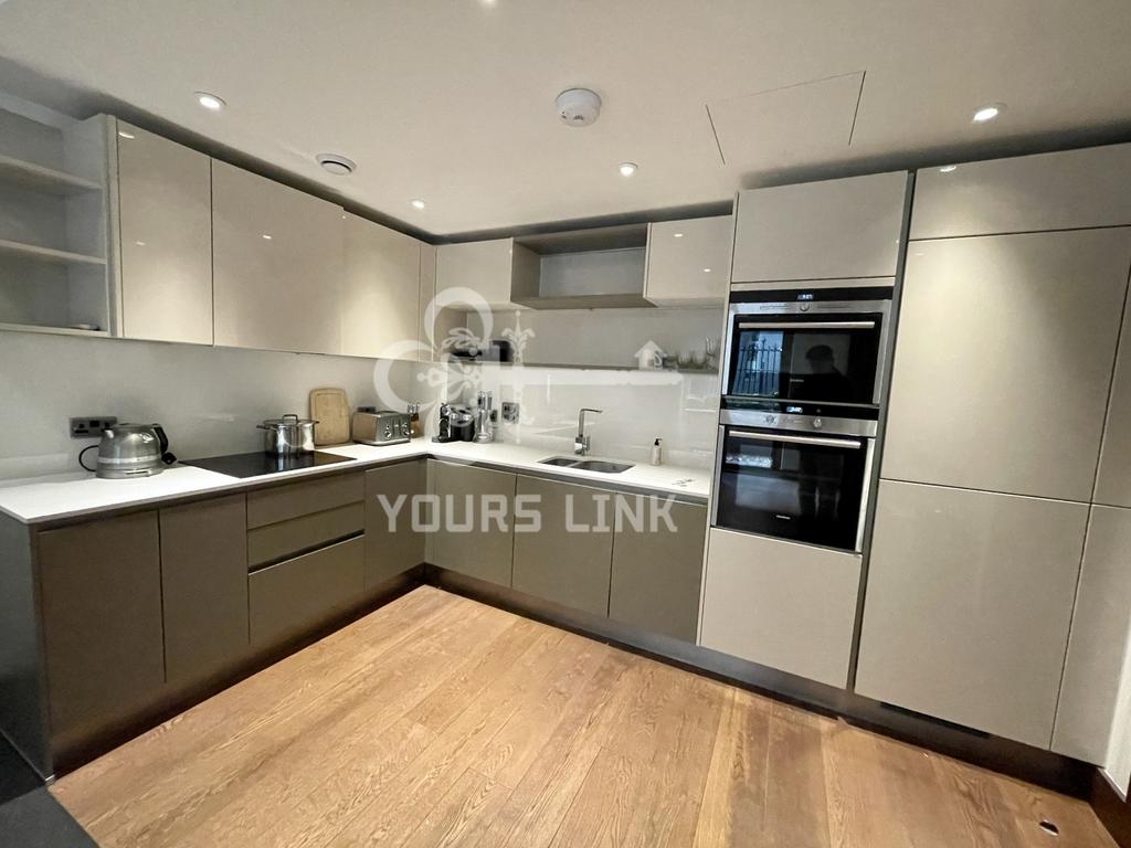 A modern and tidy kitchenette featuring sleek c...