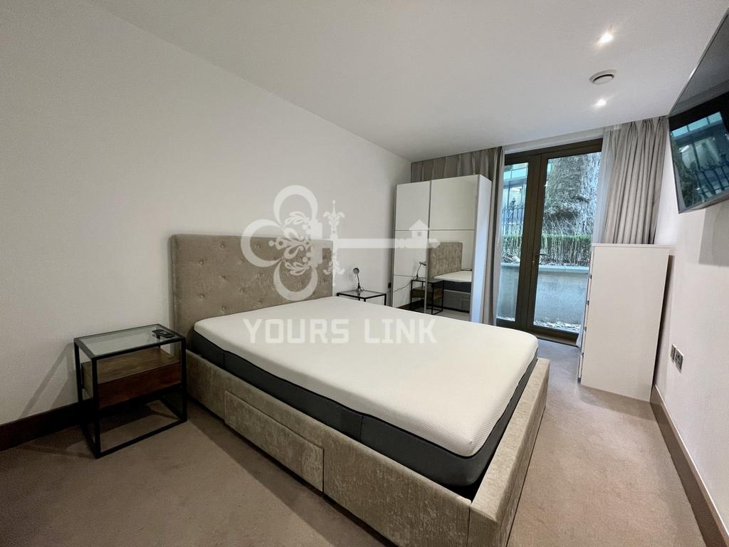 A spacious and well lit double bedroom featurin...