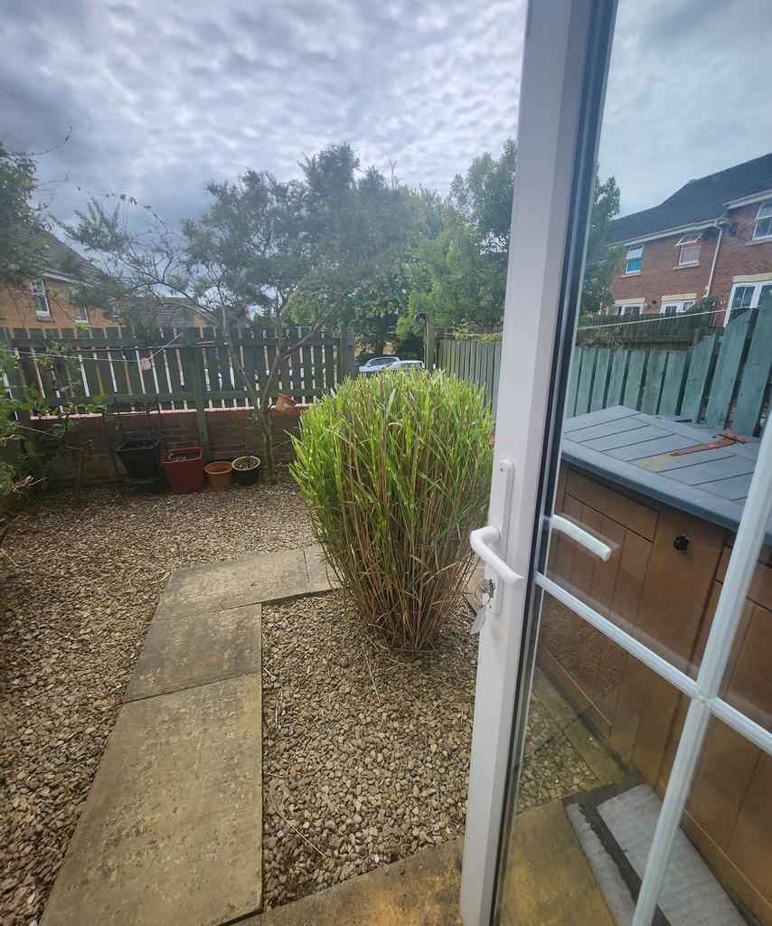 A charming garden space featuring a gravel grou...