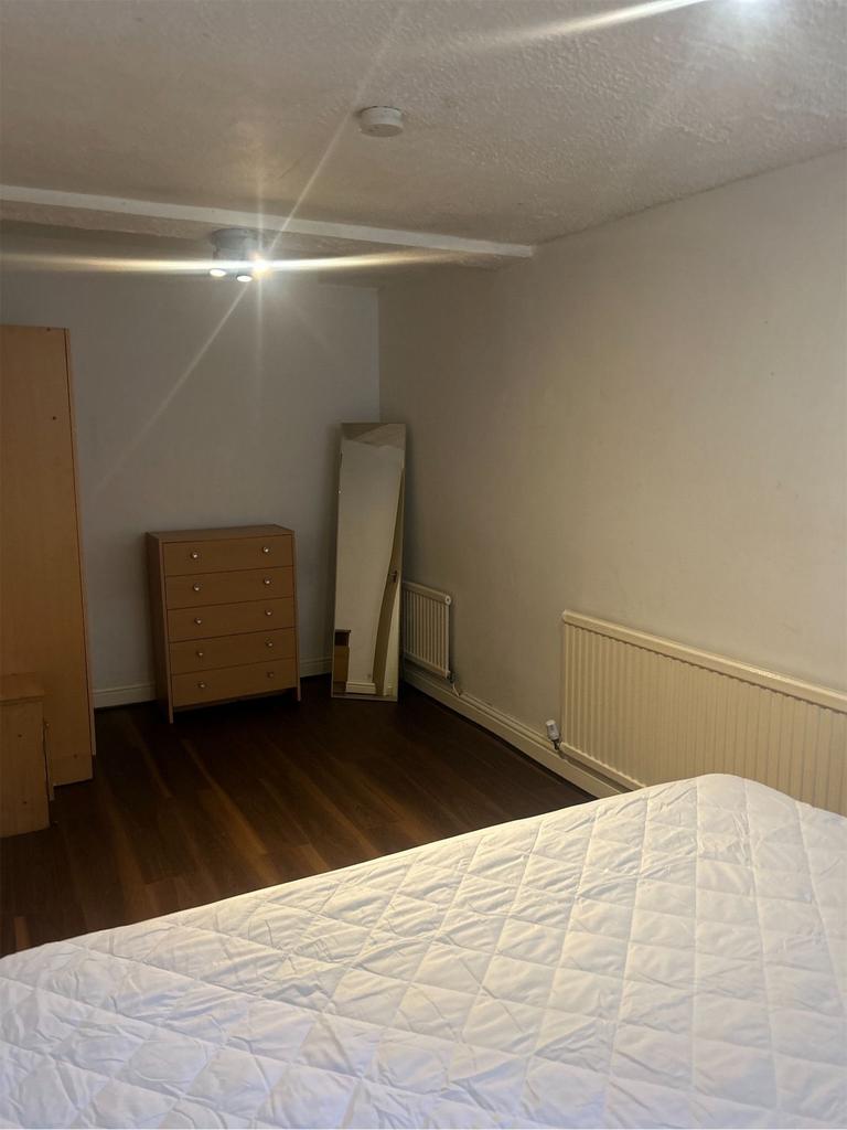 A spacious and tidy double bedroom with ample n...