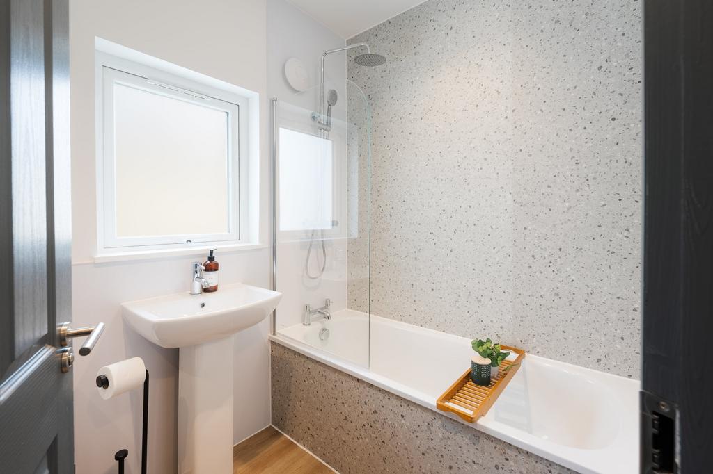 A spacious and immaculate bathroom featuring a ...