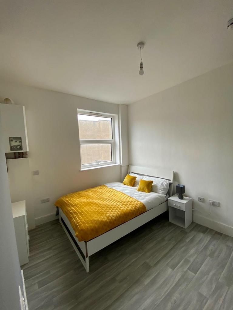 A bright and inviting double bedroom featuring ...