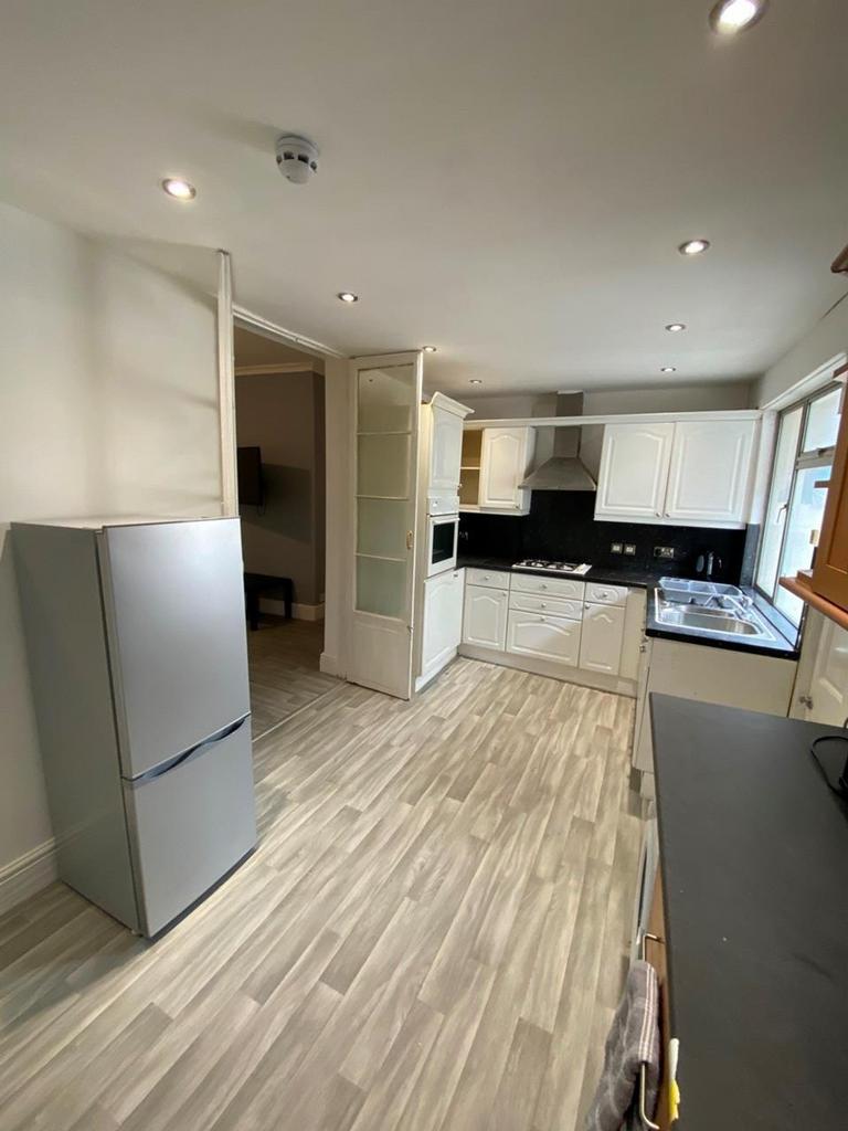 A bright and clean kitchen featuring modern app...