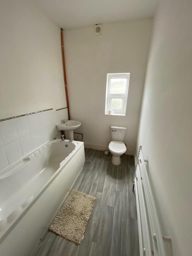 A clean and inviting bathroom featuring a bath,...