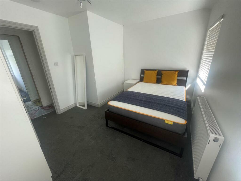 A clean and well lit double bedroom featuring a...