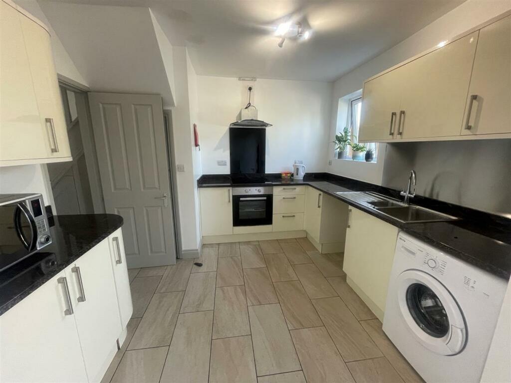 A clean and bright kitchen with modern applianc...