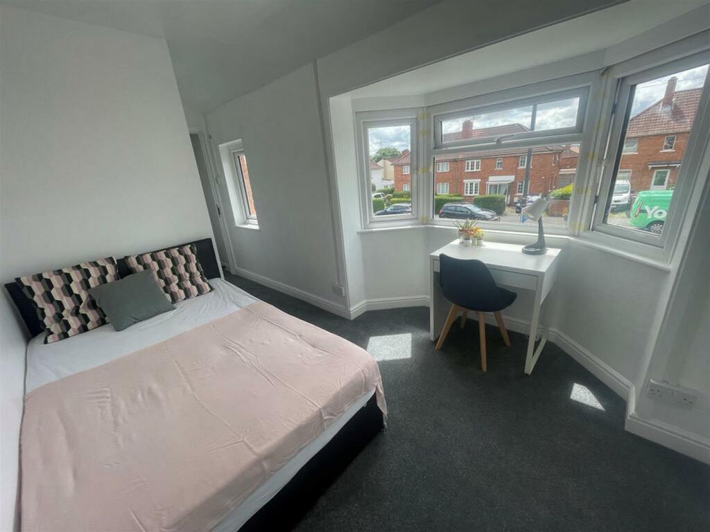 A bright and spacious double bedroom featuring ...