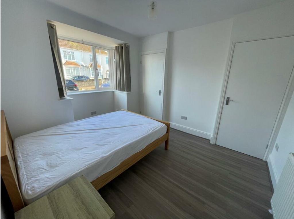 A bright and spacious double bedroom with natur...