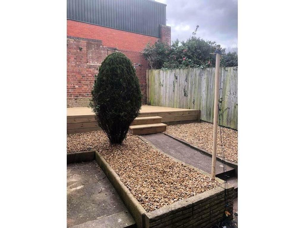 A well maintained garden area featuring gravel ...