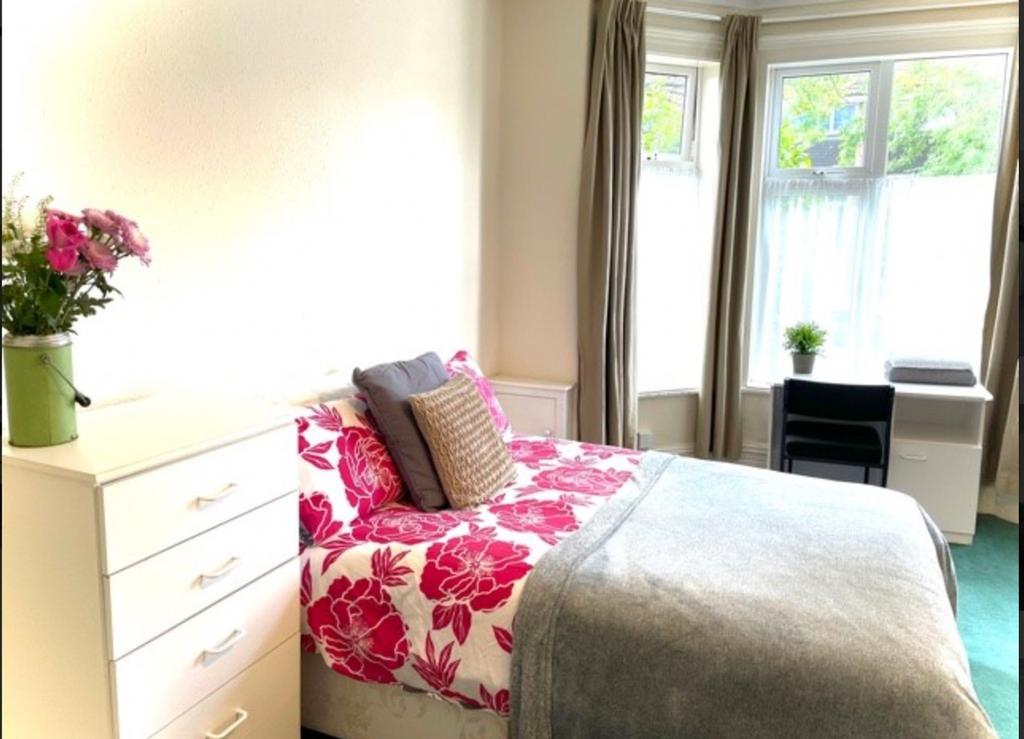 A bright and inviting double bedroom featuring ...