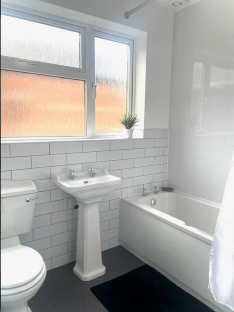 A bright and modern bathroom featuring clean fi...