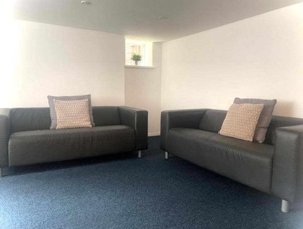 A spacious and inviting living room with comfor...