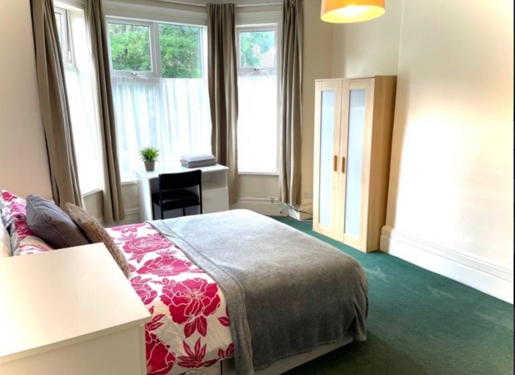 A bright and spacious double bedroom featuring ...