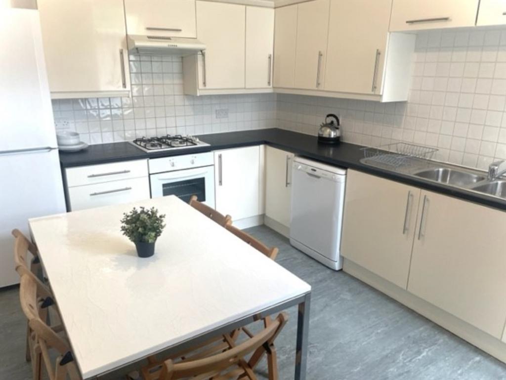 A bright and modern kitchenette with ample spac...