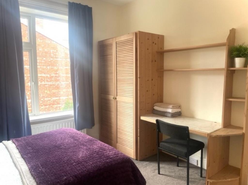 A bright and inviting double bedroom featuring ...