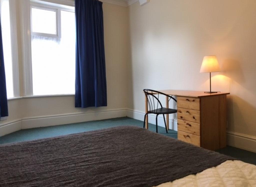 A bright and inviting double bedroom featuring ...
