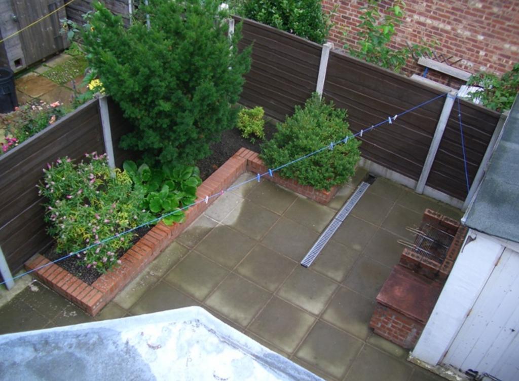 A charming garden area with well-maintained pla...