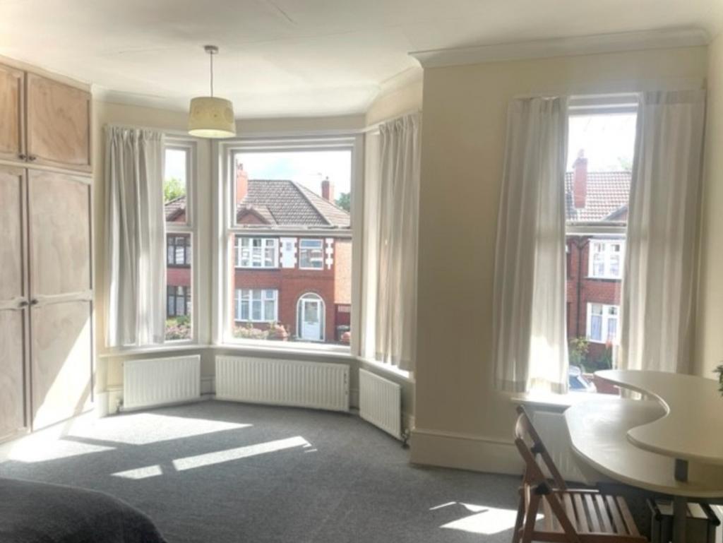 A spacious and bright double bedroom with large...