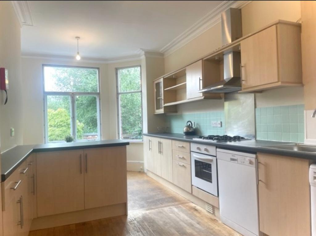 A spacious and bright kitchen featuring modern ...