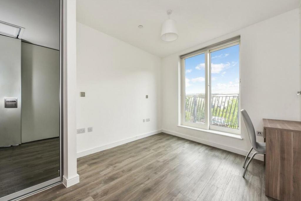 A bright and spacious double bedroom featuring ...