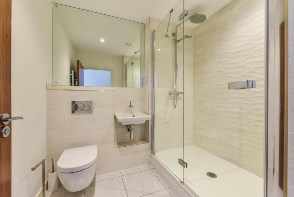 A modern and clean bathroom featuring a glass s...