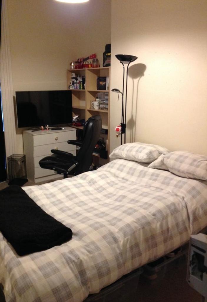 A cozy double bedroom with ample storage and a ...