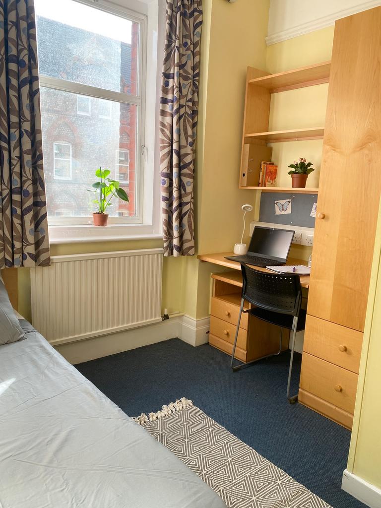 A bright and tidy double bedroom with a study a...