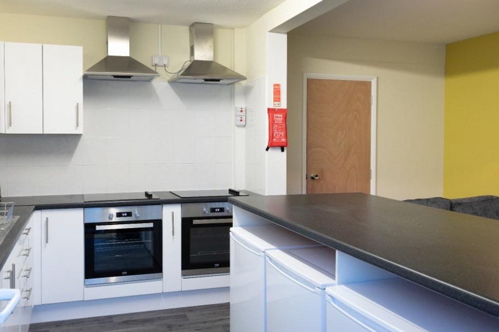 A modern and tidy kitchen with ample space for ...