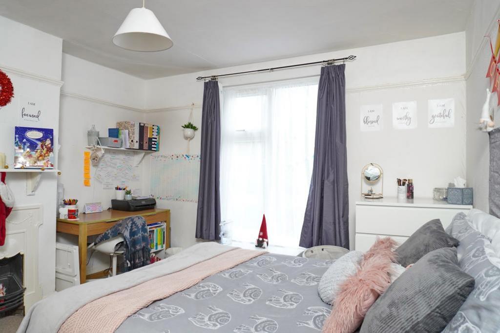 A bright and inviting double bedroom featuring ...