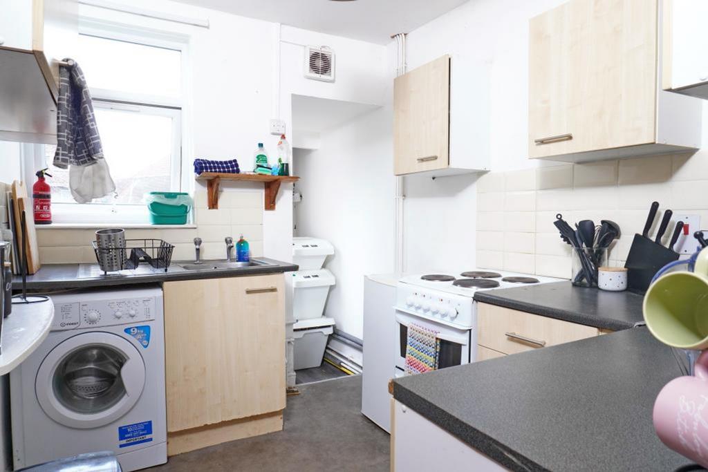 A functional and tidy kitchen equipped with nec...