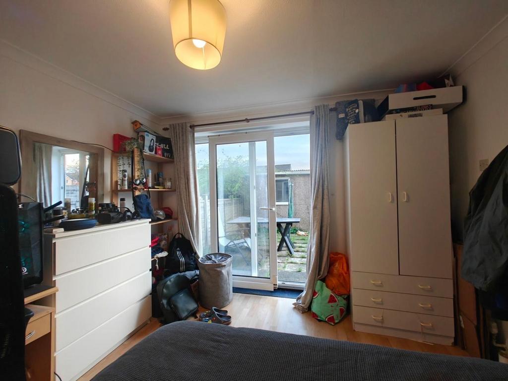 A cozy double bedroom with access to a garden, ...