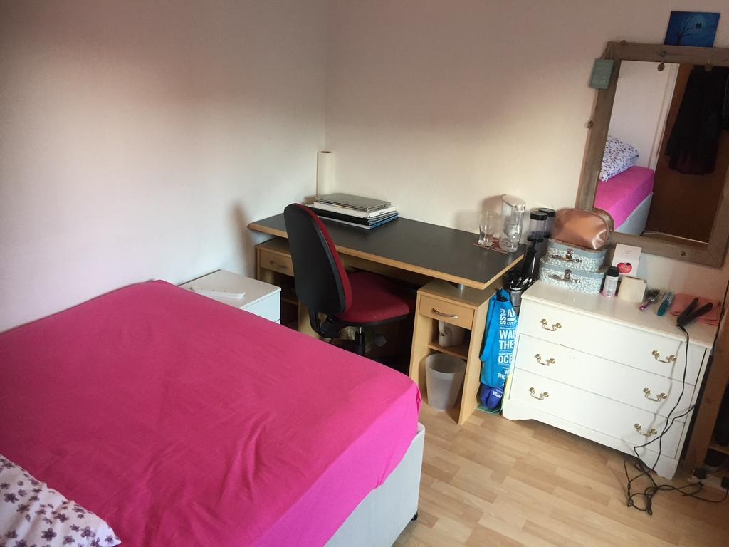 Bright, tidy bedroom with a double bed dressed ...