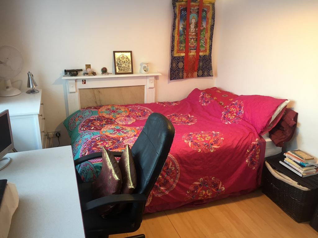 Bright, colorful double bedroom with patterned ...