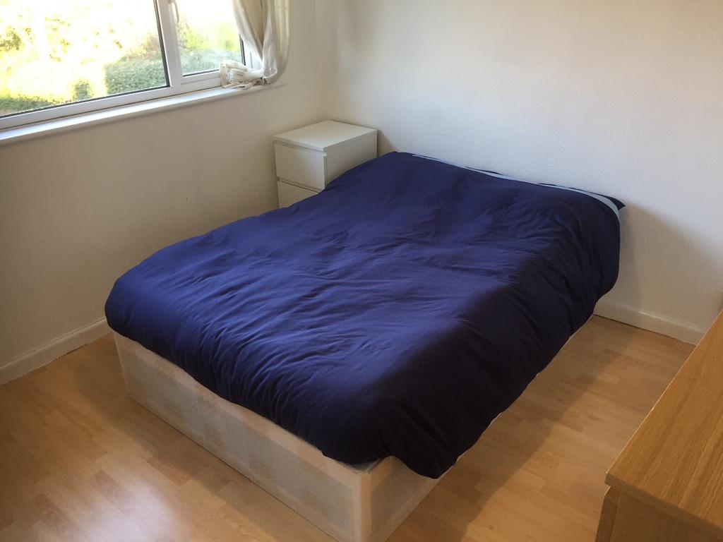 Bright, simply furnished double bedroom with a ...