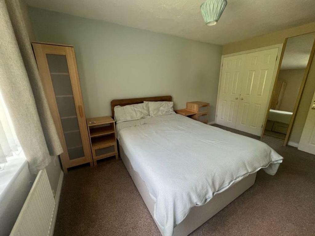 A spacious and inviting double bedroom featurin...