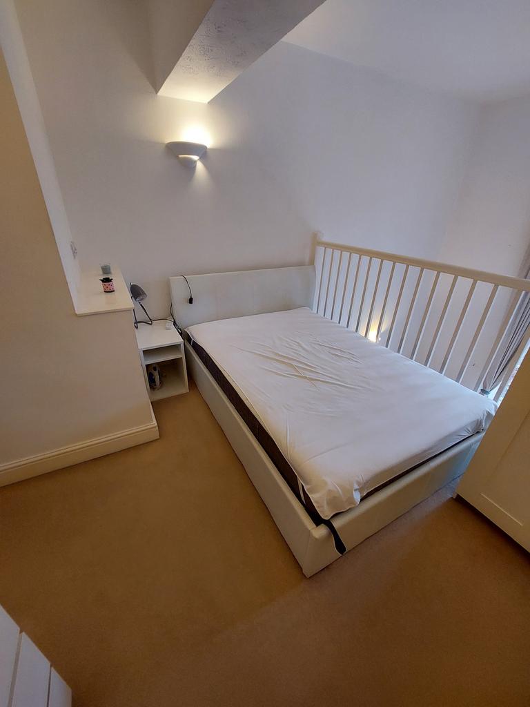 A bright and tidy double bedroom with a comfort...