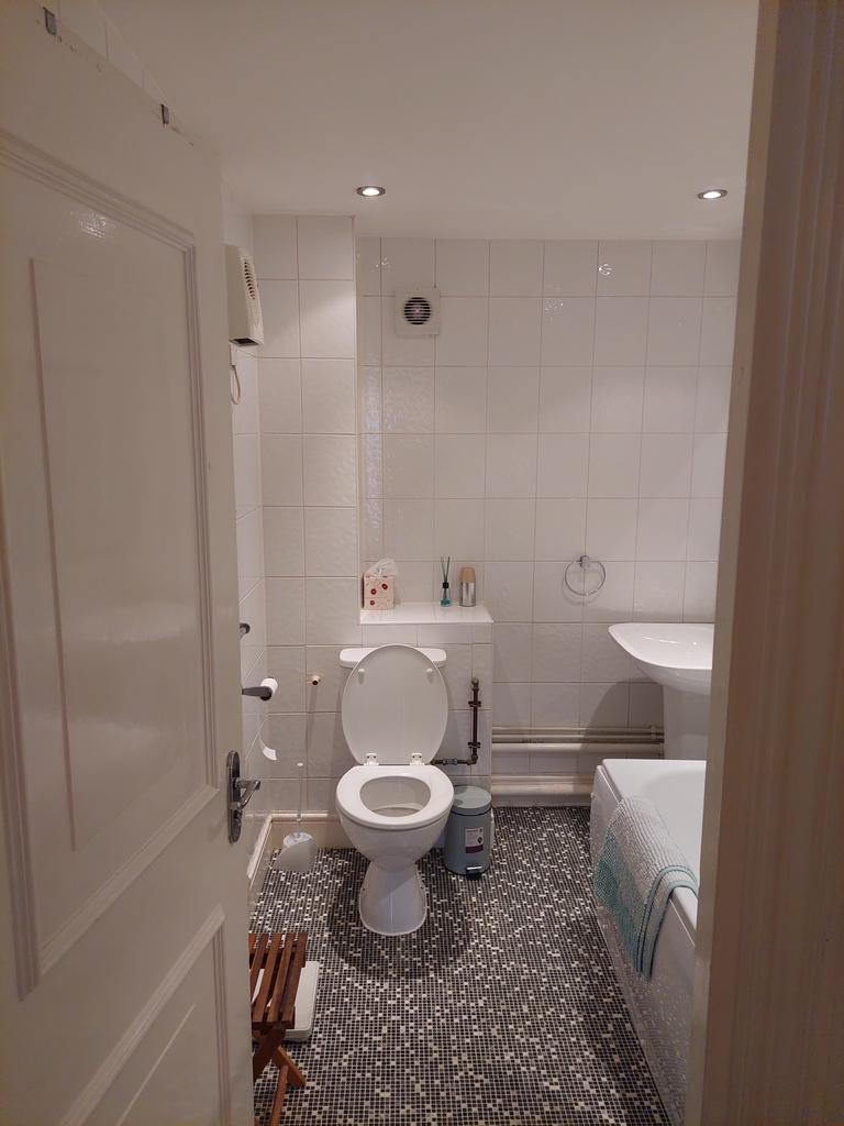 A bright and tidy bathroom featuring modern fix...