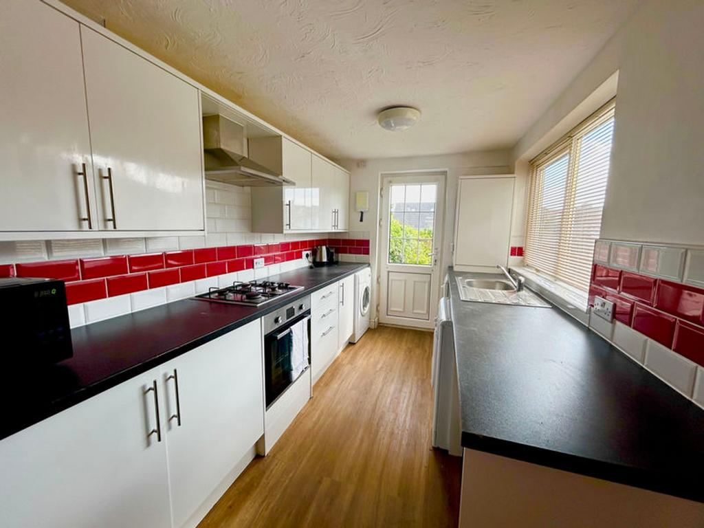 A modern and spacious kitchen featuring ample s...